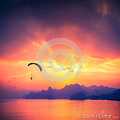 Paraglide silhouette over the sea sunset Stock Photo