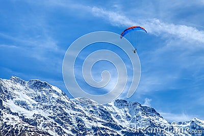 Paraglider in the blue sky. The sportsman flying on a paraglider Editorial Stock Photo
