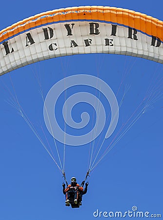 A paraglider flies above Oludeniz Beach on the Turquoise Coast of Turkey. Editorial Stock Photo