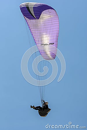 A paraglider flies above Oludeniz Beach on the Turquoise Coast of Turkey. Editorial Stock Photo