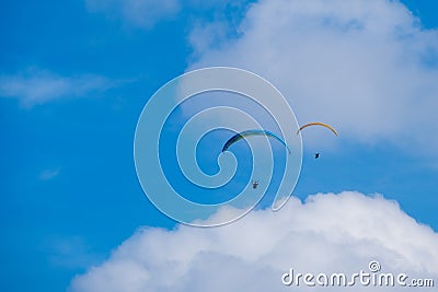Paraglider flies in the air -Aerial view of paraglider above the clouds Editorial Stock Photo