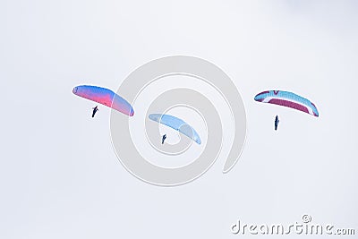 Paraglider flies in the air -Aerial view of paraglider above the clouds Editorial Stock Photo