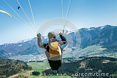 Paraglider is on the paraplane strops - soaring flight moment Stock Photo