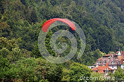 Paraglider with red wing shape in Interlaken, Switzerland. Stock Photo
