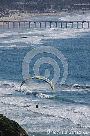 Paraglider, surfers, swimmers near Scripps Pier, La Jolla, California Stock Photo
