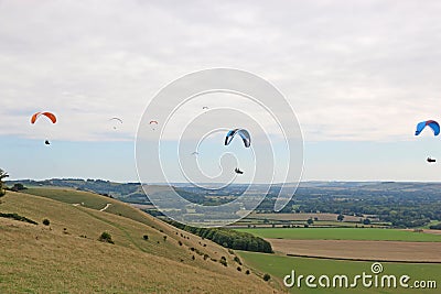 Paragliders flying from a hill Stock Photo