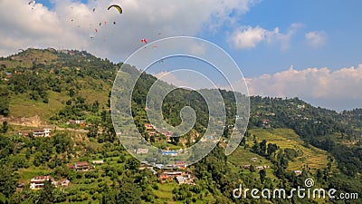 Paragliders flying over Sarangkot in Pokhara, Nepal Stock Photo