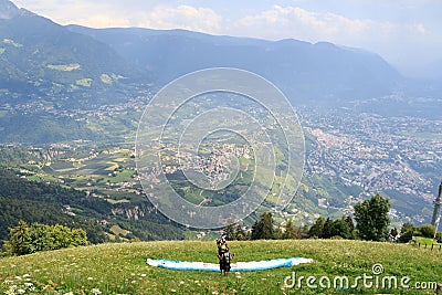 Paragliders prepare for Paragliding in front of Merano panaroma in South Tyrol Editorial Stock Photo