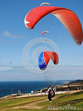 Paragliders ready to fly into the blue sky over the ocean Editorial Stock Photo