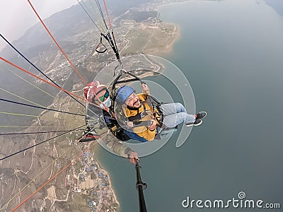 Paragliding in the mountains, the two persons on the top of the mountain, the parachutists are flying with a parachute Stock Photo