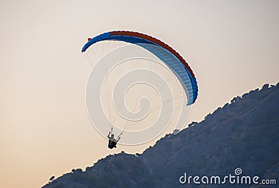 Paragliding in Oludeniz. Paraglider, airborne against blue sky. Stock Photo