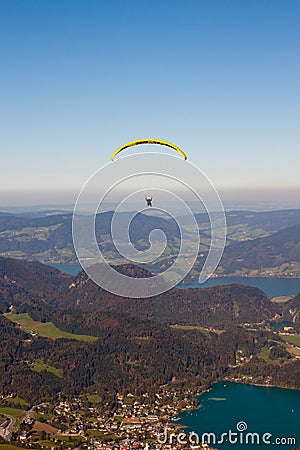 Paragliding over lake and mountains in Alps Stock Photo