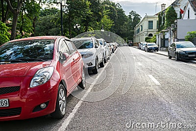 Parallel parking cars on urban street. Outdoor parking on road Editorial Stock Photo