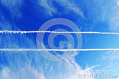 Parallel plane contrails in blue sky Stock Photo