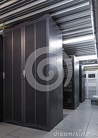 Parallel rows of server racks in datacenter, supercomputer clusters in room Stock Photo