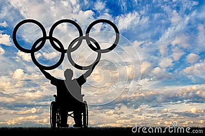 Paralympic disabled person in wheelchair hold olympic rings Editorial Stock Photo