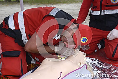 Paramedic checking sufferer heart beating and breathing, artificial respiration Editorial Stock Photo
