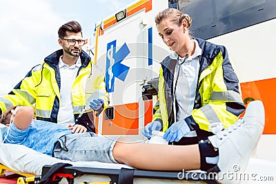 Paramedic and emergency doctor caring for injured boy Stock Photo