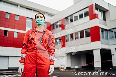 Paramedic in front of isolation hospital facility.Coronavirus Covid-19 heroes.Mental strength of medical professional.Emergency Stock Photo