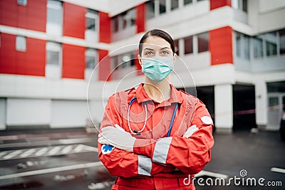 Paramedic in front of isolation hospital facility.Coronavirus Covid-19 heroes.Mental strength of medical professional.Emergency Stock Photo