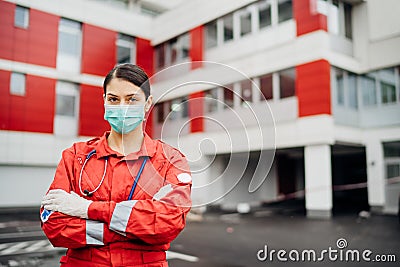 Paramedic in front of isolation hospital facility.Coronavirus Covid-19 heroes.Mental strength of medical professional.Emergency Stock Photo