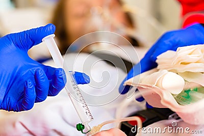 Paramedic giving infusion in ambulance Stock Photo