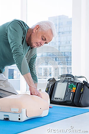 Paramedic practicing resuscitation on dummy Stock Photo