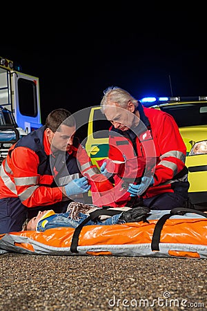 Paramedic team giving firstaid to injured woman Stock Photo
