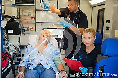 Paramedic treating injured patient in ambulance Stock Photo