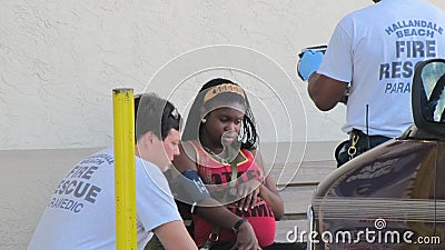 Paramedics Assist Woman Editorial Stock Photo