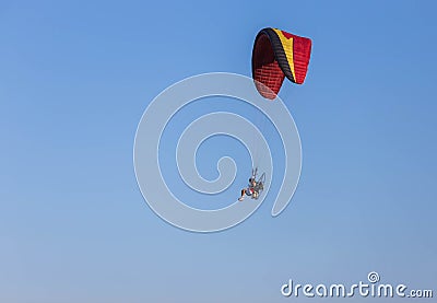 Paramotor flying on blue sky background Editorial Stock Photo