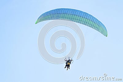 Paramotor pilot and his tourist client flying in the sky Stock Photo