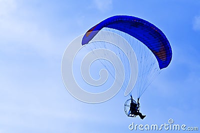 Paramotor silhouette in blue sky Stock Photo