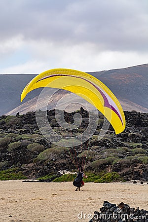 Paraplaner with paraplane on sandy beach, extreme sport Editorial Stock Photo