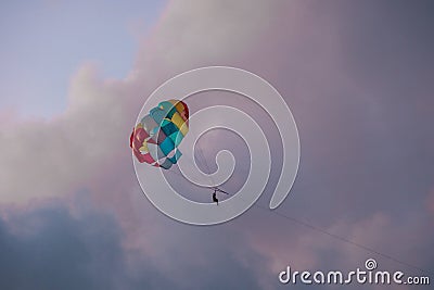 Bright parachute on a background of a sunset sky. Stock Photo