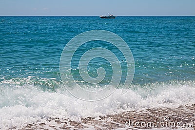 Parasailing speed boat near the rocky shore Stock Photo