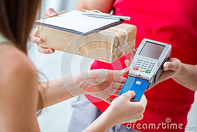 The parcel delivery being paid with pos and credit card Stock Photo