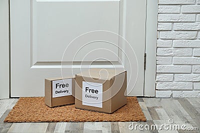 Parcels with stickers Free Delivery on rug. Courier service Stock Photo