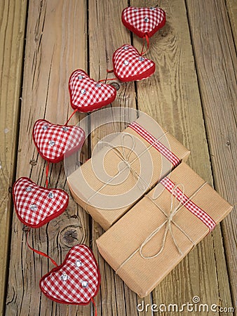 Parcels wrapped in brown paper and string with red check hearts Stock Photo