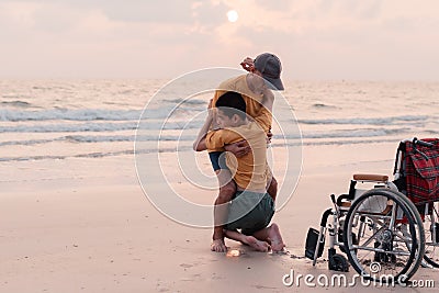 Teenage boy with disability on the beach Stock Photo