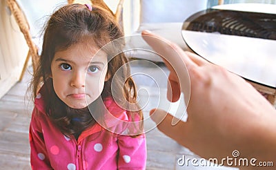 Parent hand yelling blaming and scolding child reproaching baby girl daughter Stock Photo