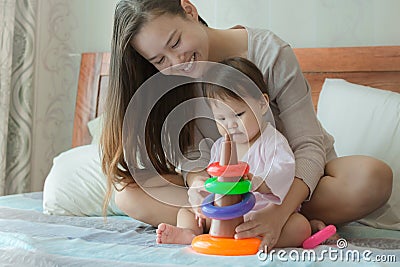 Mom teaching her baby with toys at home Stock Photo