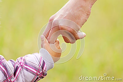 Parent holds the hand of a small child Stock Photo