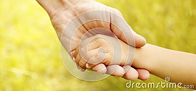 Parent holds the hand of a small child Stock Photo