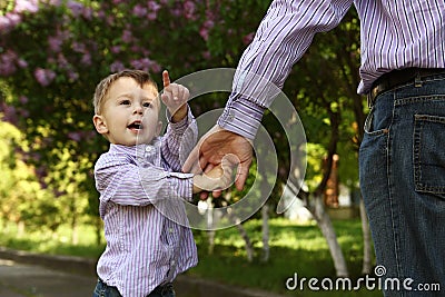 Parent holds the hand of a small child Stock Photo