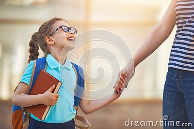 Parent and pupil go to school Stock Photo