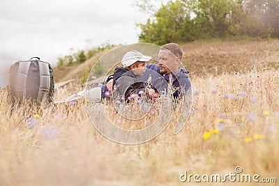 Parent talking child nature lying grass meadow Stock Photo