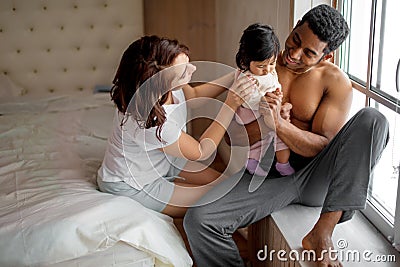 Parental care. young woman and man giving family love to their sweet daughter Stock Photo