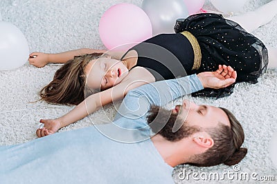 Parenting lifestyle tired father asleep daughter Stock Photo