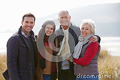 Parents With Adult Offspring Standing In Dunes Stock Photo